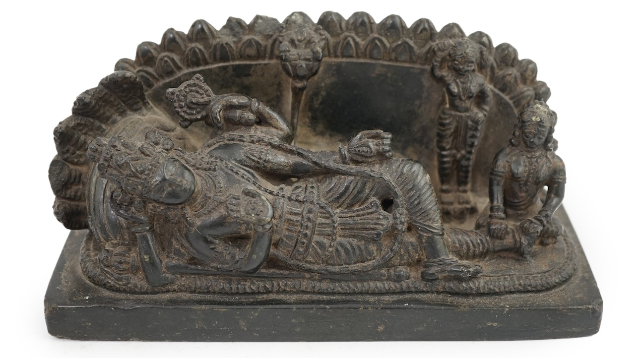 An Indian basalt reclining figure of Shiva, probably Kakatiya period, 12th century A.D